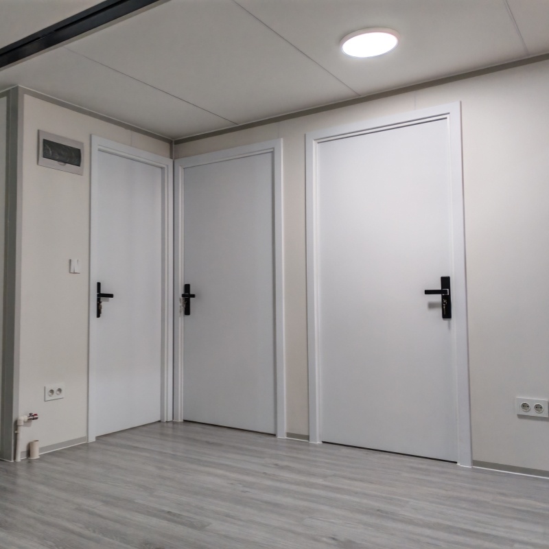Sleek and modern bathroom design inside an expandable container house with shower, toilet, and wash basin