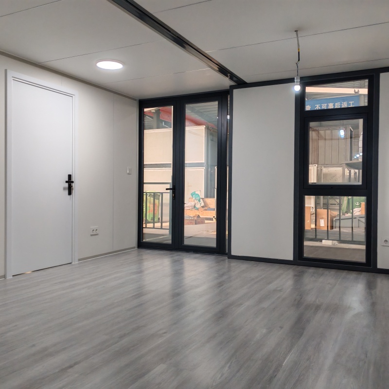 Interior view of a spacious and modern bathroom inside an expandable container house featuring shower, sink, and toilet