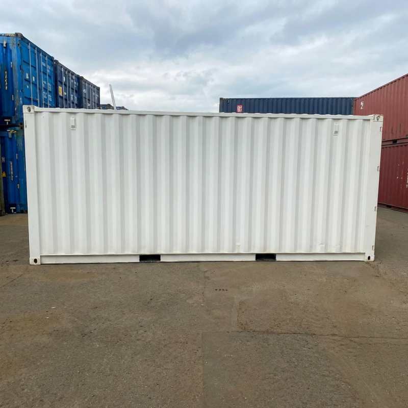 Heavy duty dry box container with clean exterior finish staged in an open yard from a China container house manufacturer for commercial storage use