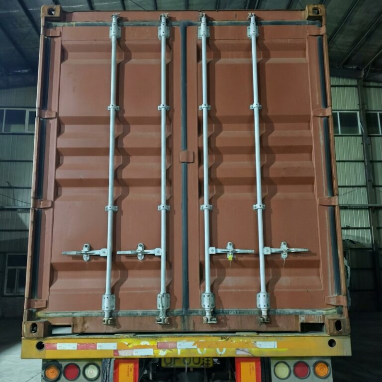 Rear view of transport container house during logistics loading, showing reinforced container doors and locking system, manufactured by China container house factory for bulk export and modular housing transportation.
