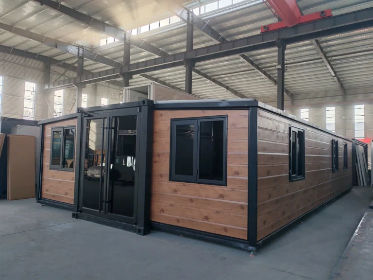A premium black expandable container house designed for Canada, shown installed in a heavy snowy environment with a decorated Christmas tree to demonstrate high thermal insulation and snow-load durability.